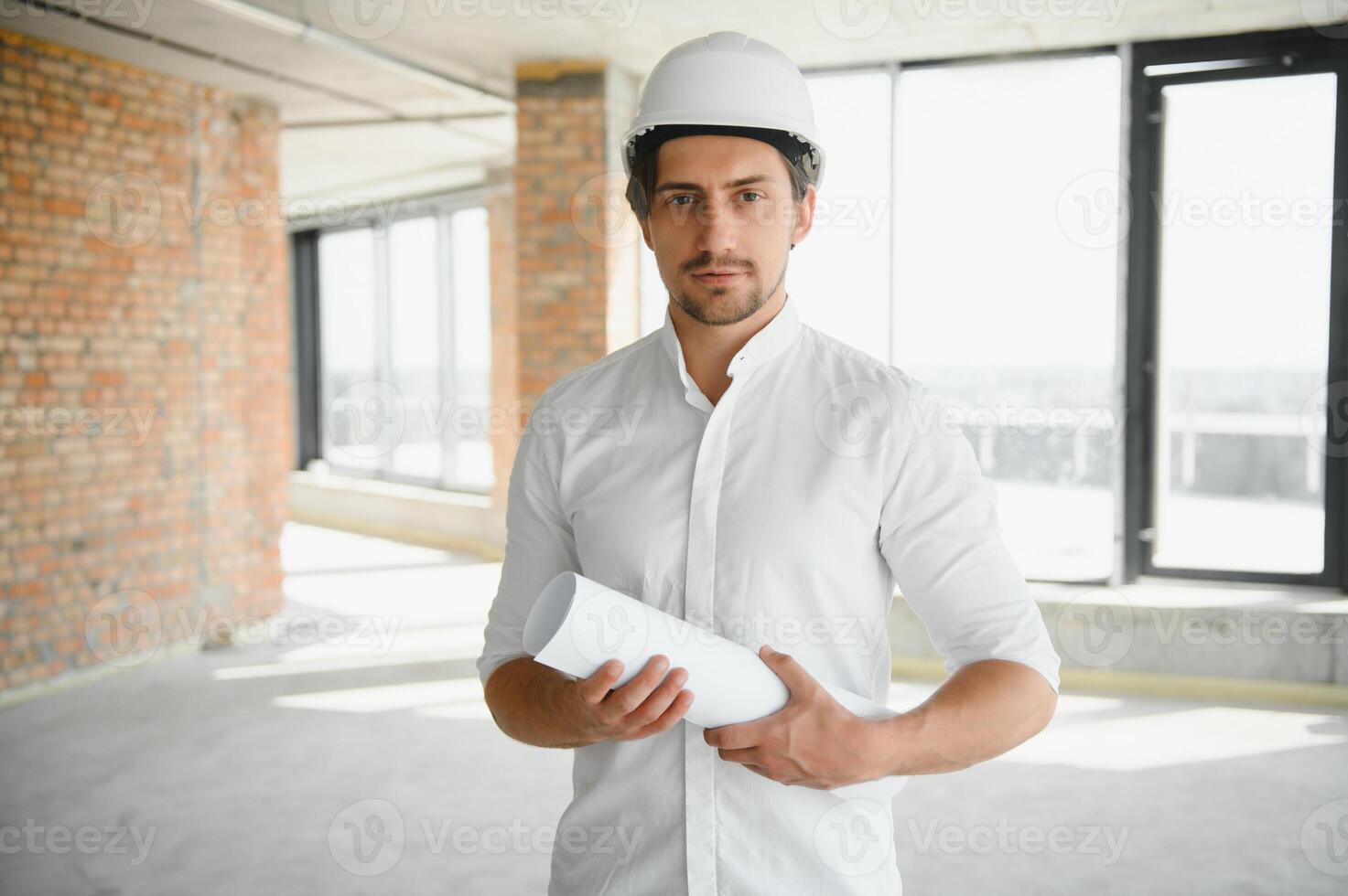 Close up engineers working on a building site holding a blueprints.Engineering and architecture concept photo