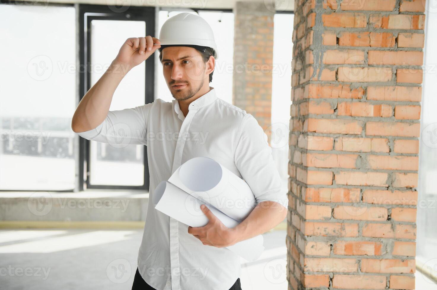 Close up engineers working on a building site holding a blueprints.Engineering and architecture concept photo