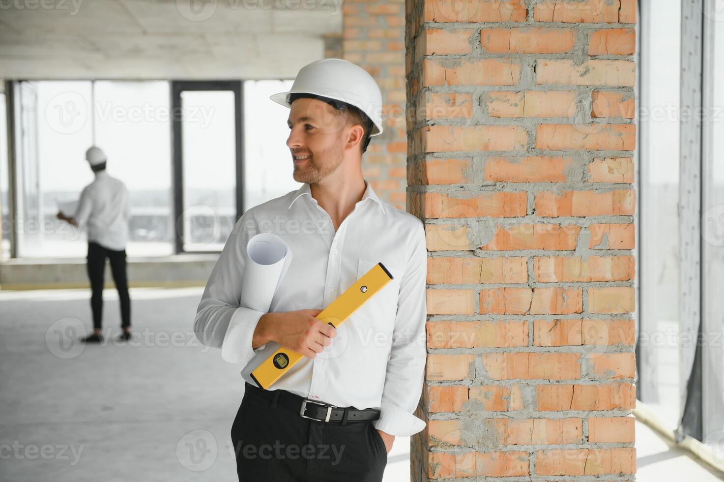 Close up engineers working on a building site holding a blueprints.Engineering and architecture concept photo