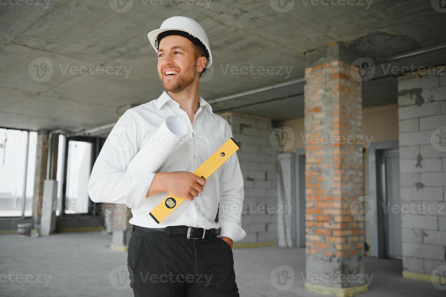 Business architect man wearing hardhat standing of a building project photo