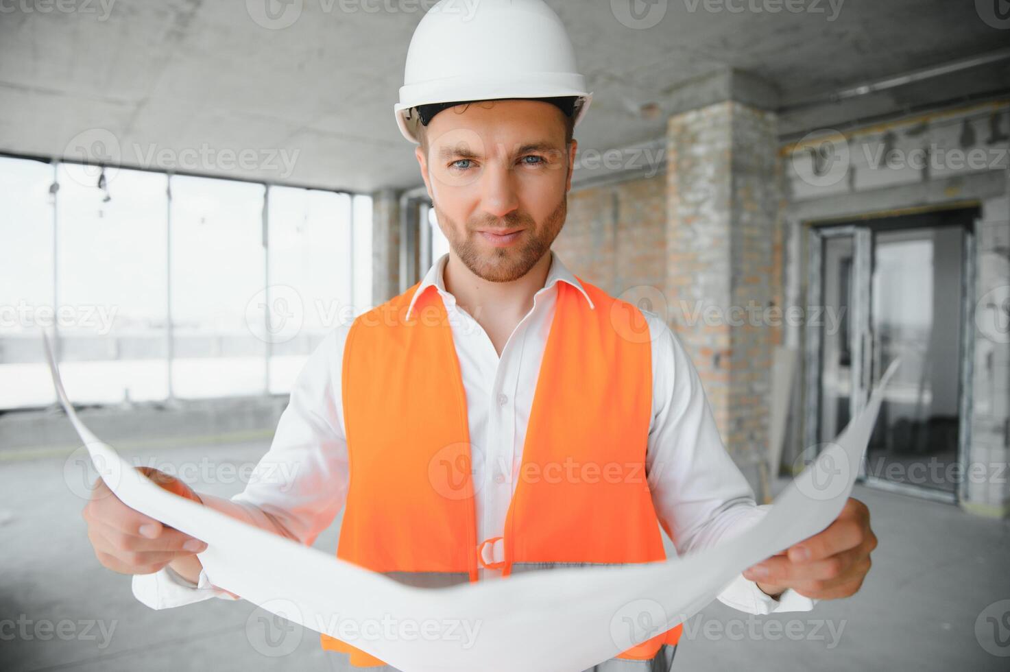 Close up engineers working on a building site holding a blueprints.Engineering and architecture concept photo