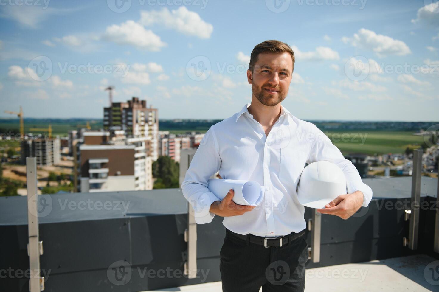 Close up engineers working on a building site holding a blueprints.Engineering and architecture concept photo