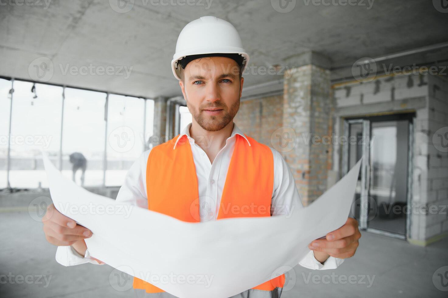 Portrait of an architect builder studying layout plan of the rooms, serious civil engineer working with documents on construction site, building and home renovation, professional foreman at work. photo