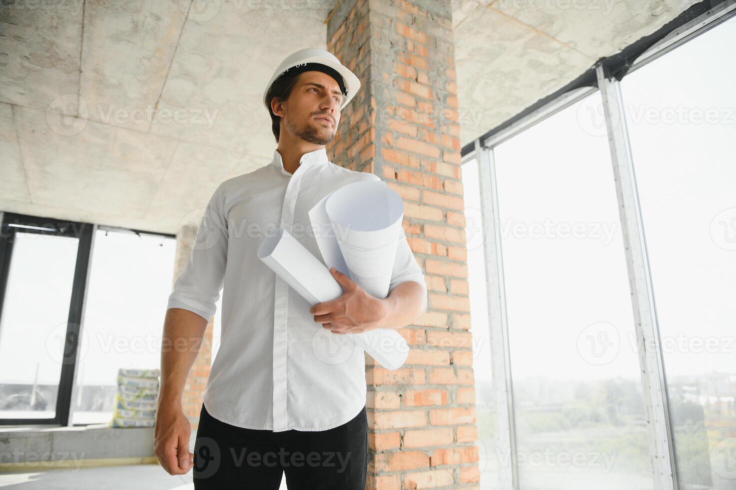 Close up engineers working on a building site holding a blueprints.Engineering and architecture concept photo