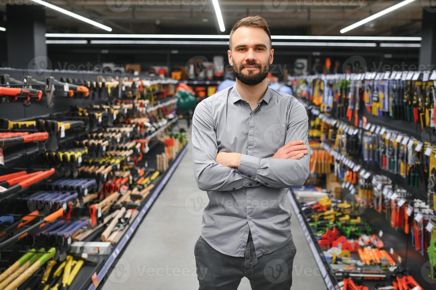 Portrait of happy mature man standing in hardware store photo