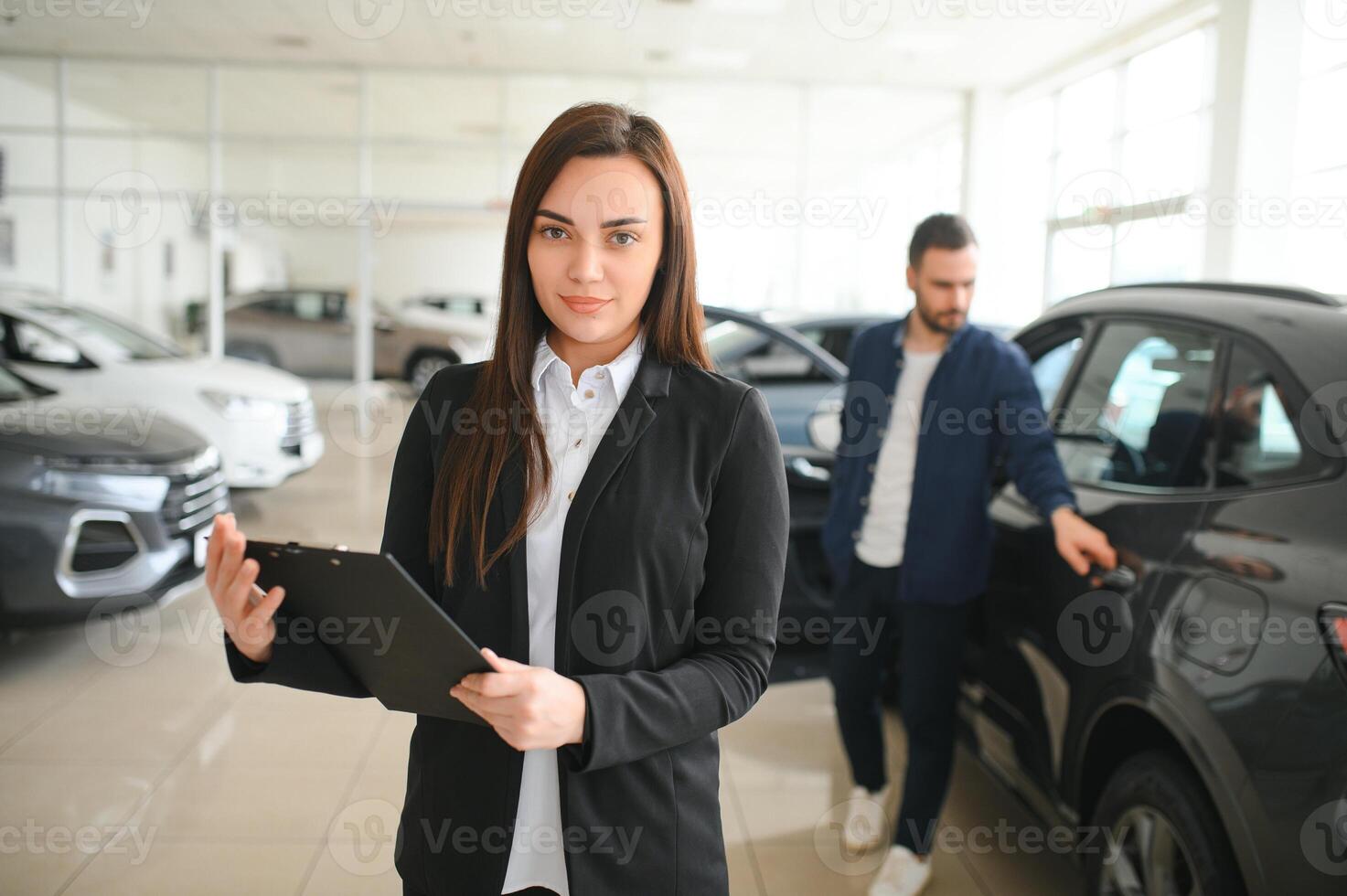 Salesperson selling cars at car dealership photo