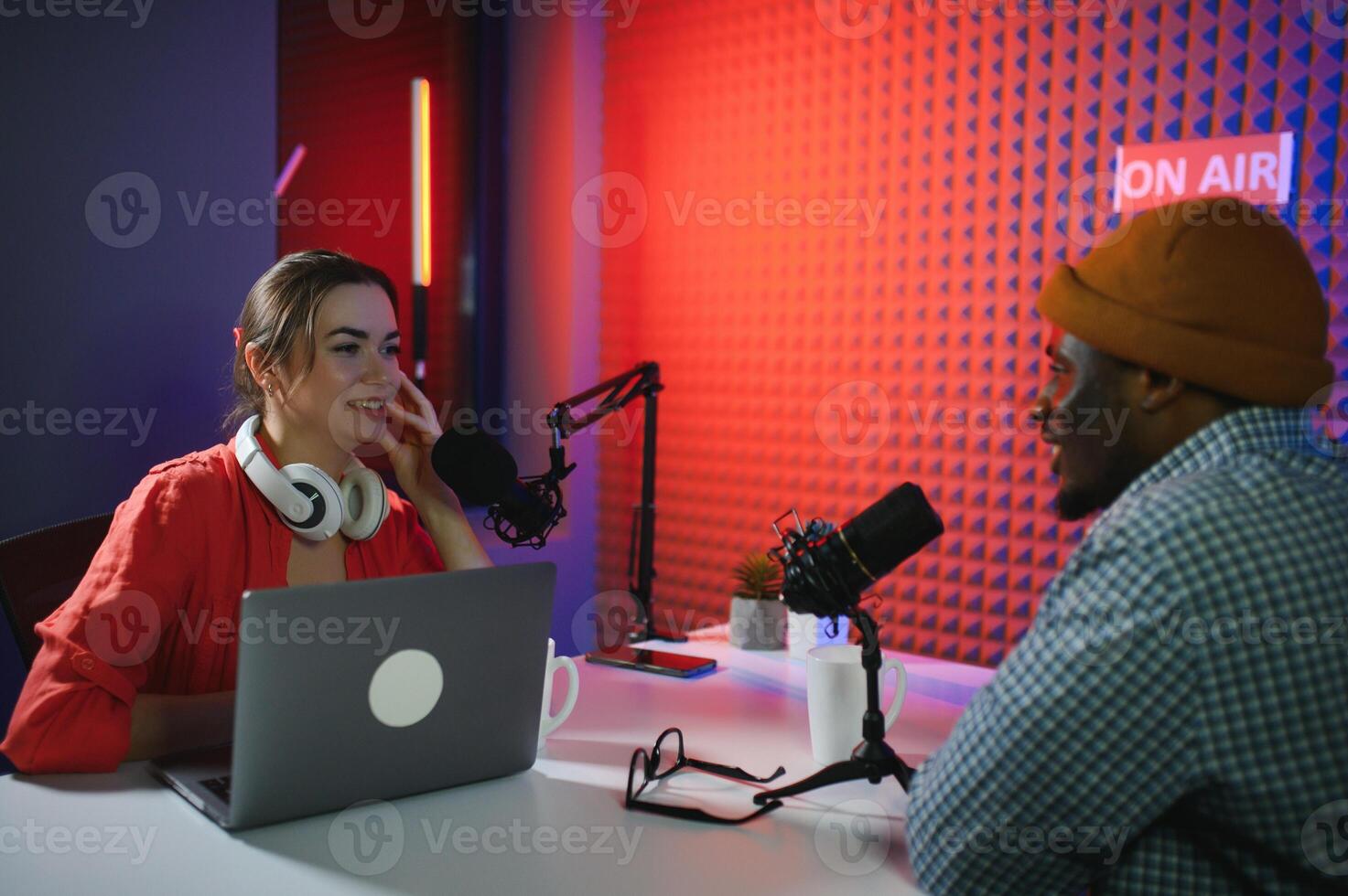 Man and woman livestreaming online discussion on podcast episode, recording live for internet content photo