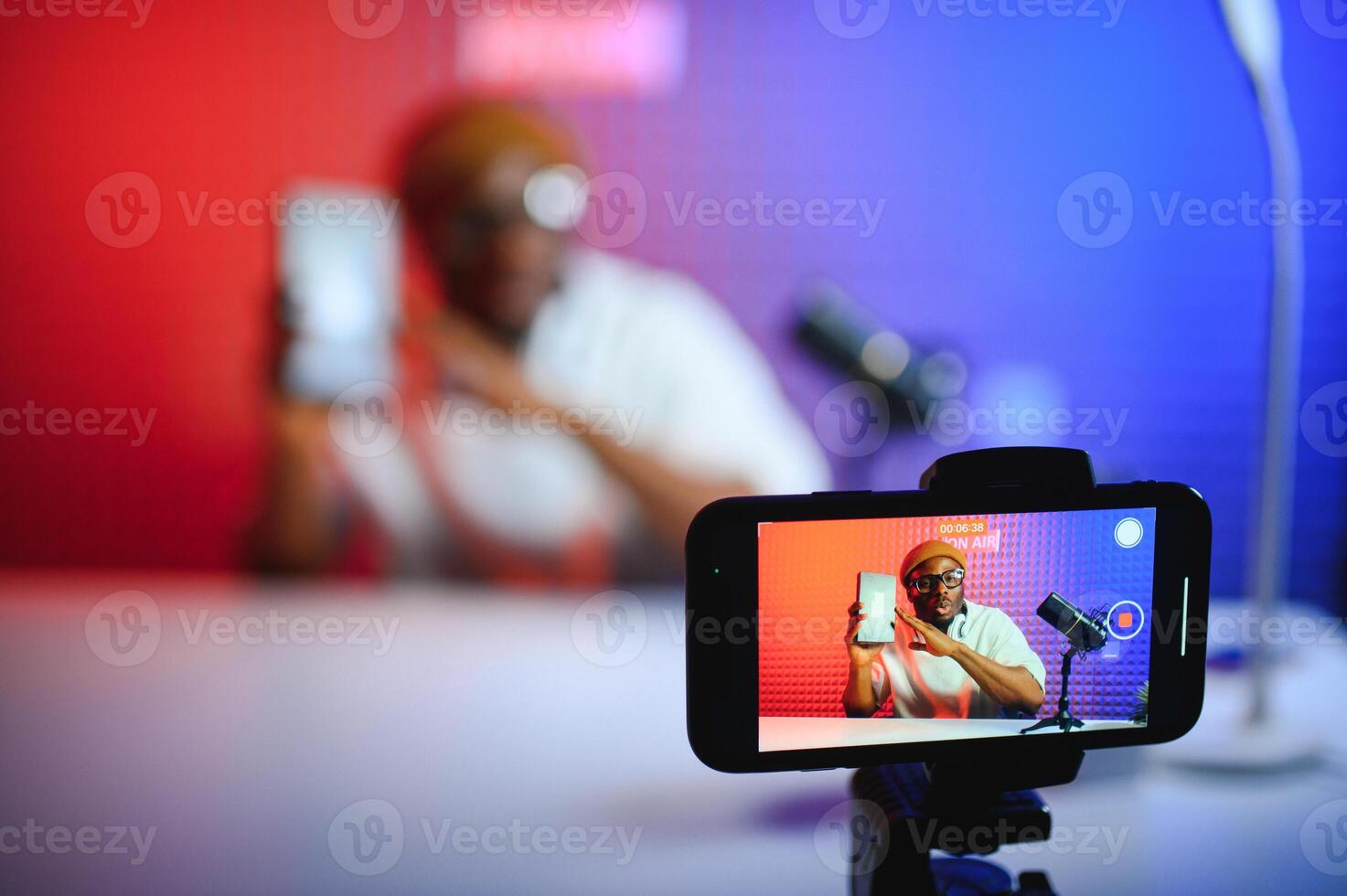 African american blogger unboxing new smartphone and recording on camera photo