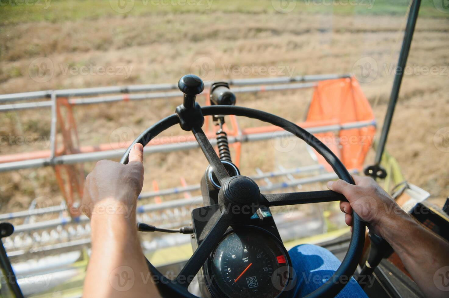 Farmer controls the combine harvester. photo