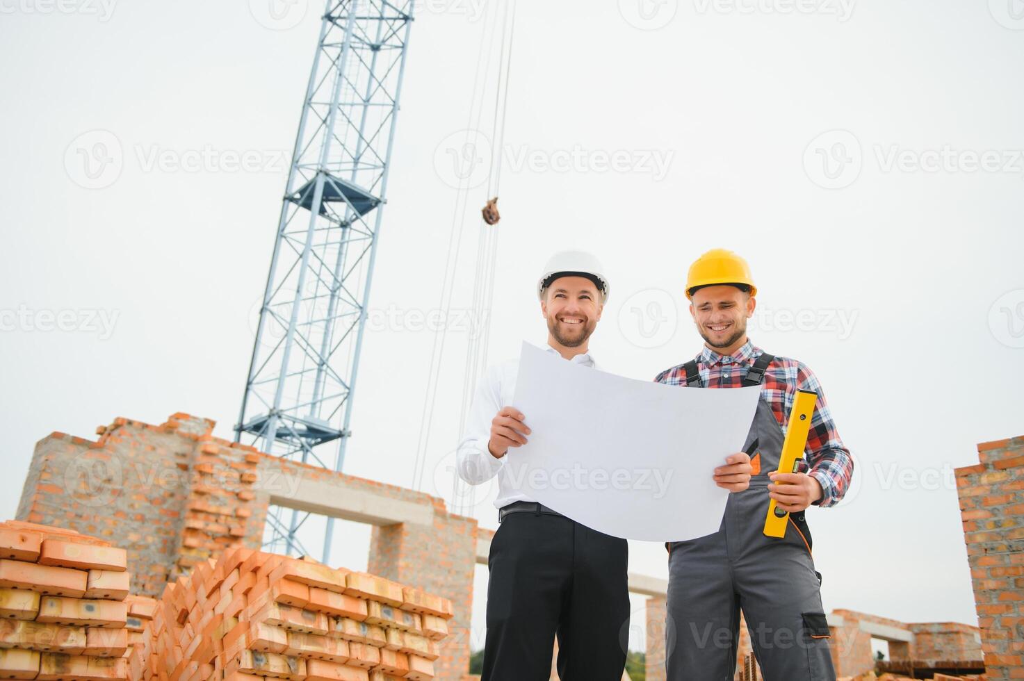 Structural engineer and foreman worker discuss, plan working for the outdoors building construction site photo
