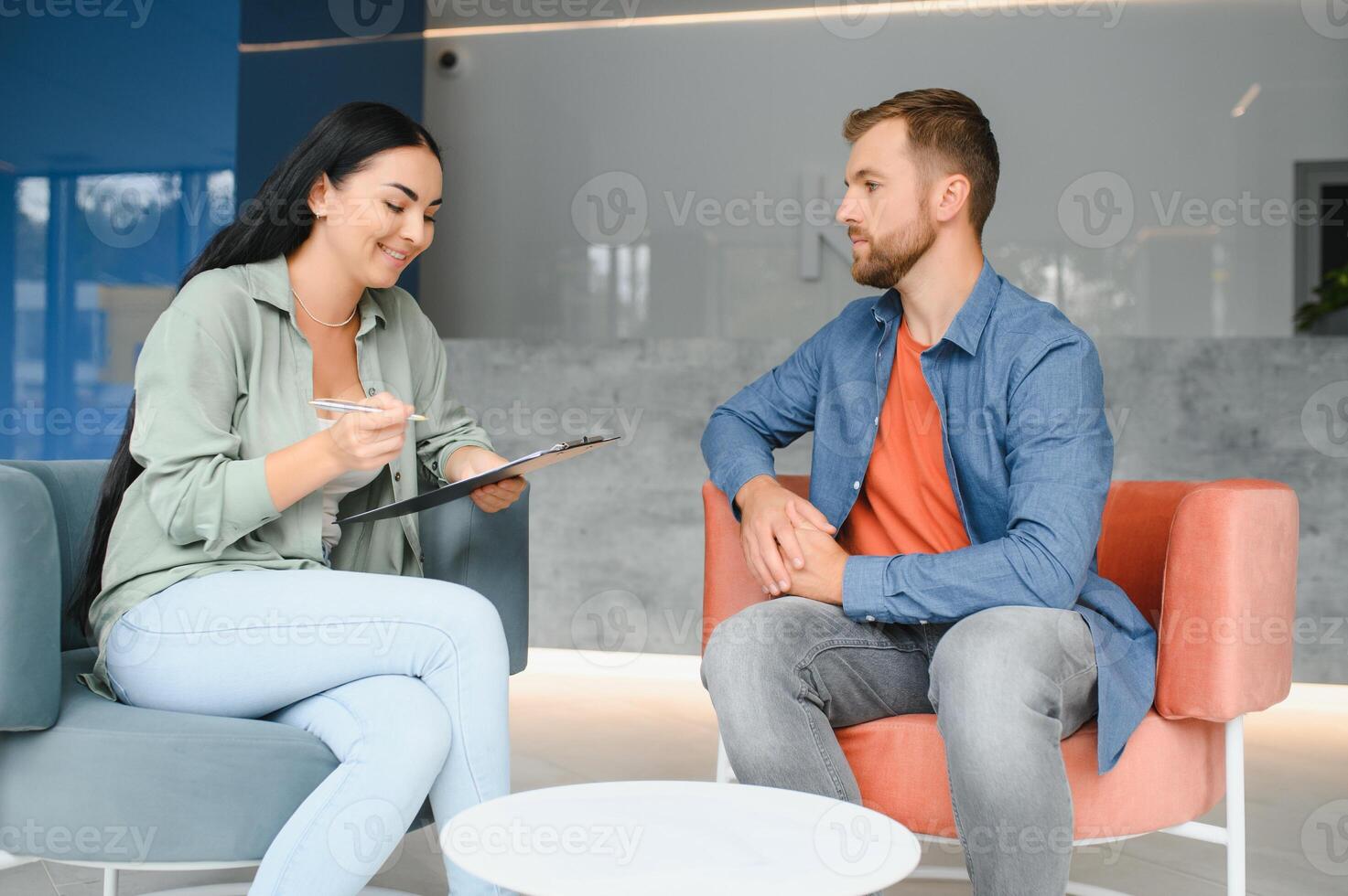 Business concept. Young dark-haired woman sitting in front of mature cheerful office manager on job interview, having relaxing talk about her experience and study degree. photo