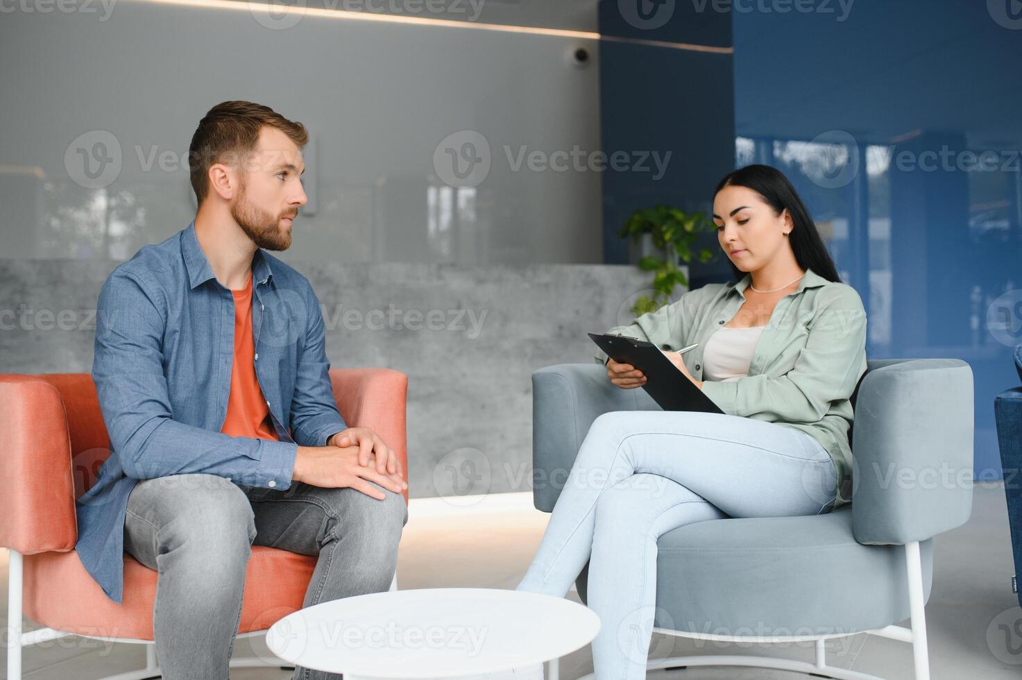 Business concept. Young dark-haired woman sitting in front of mature cheerful office manager on job interview, having relaxing talk about her experience and study degree. photo