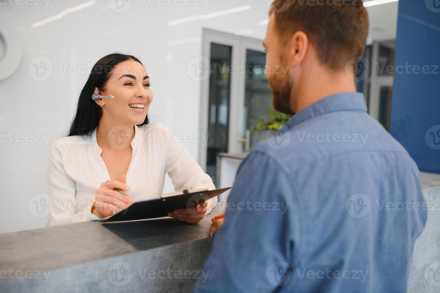 Excellent service. Nice friendly woman talking to the client while standing at the reception. photo