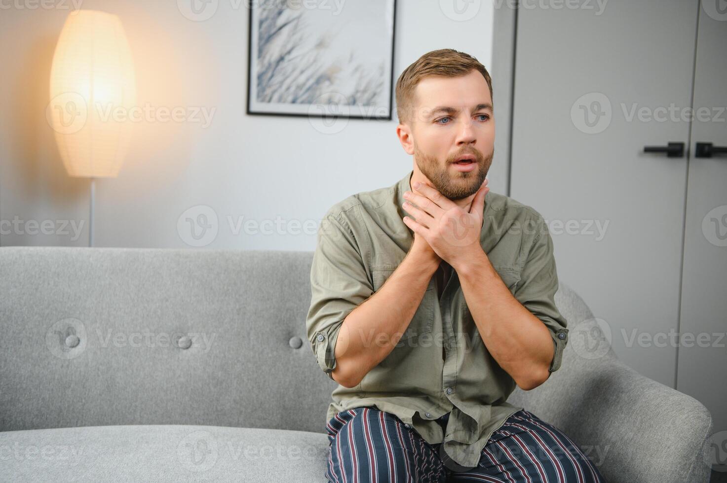 Handsome man having a sore throat at his home photo