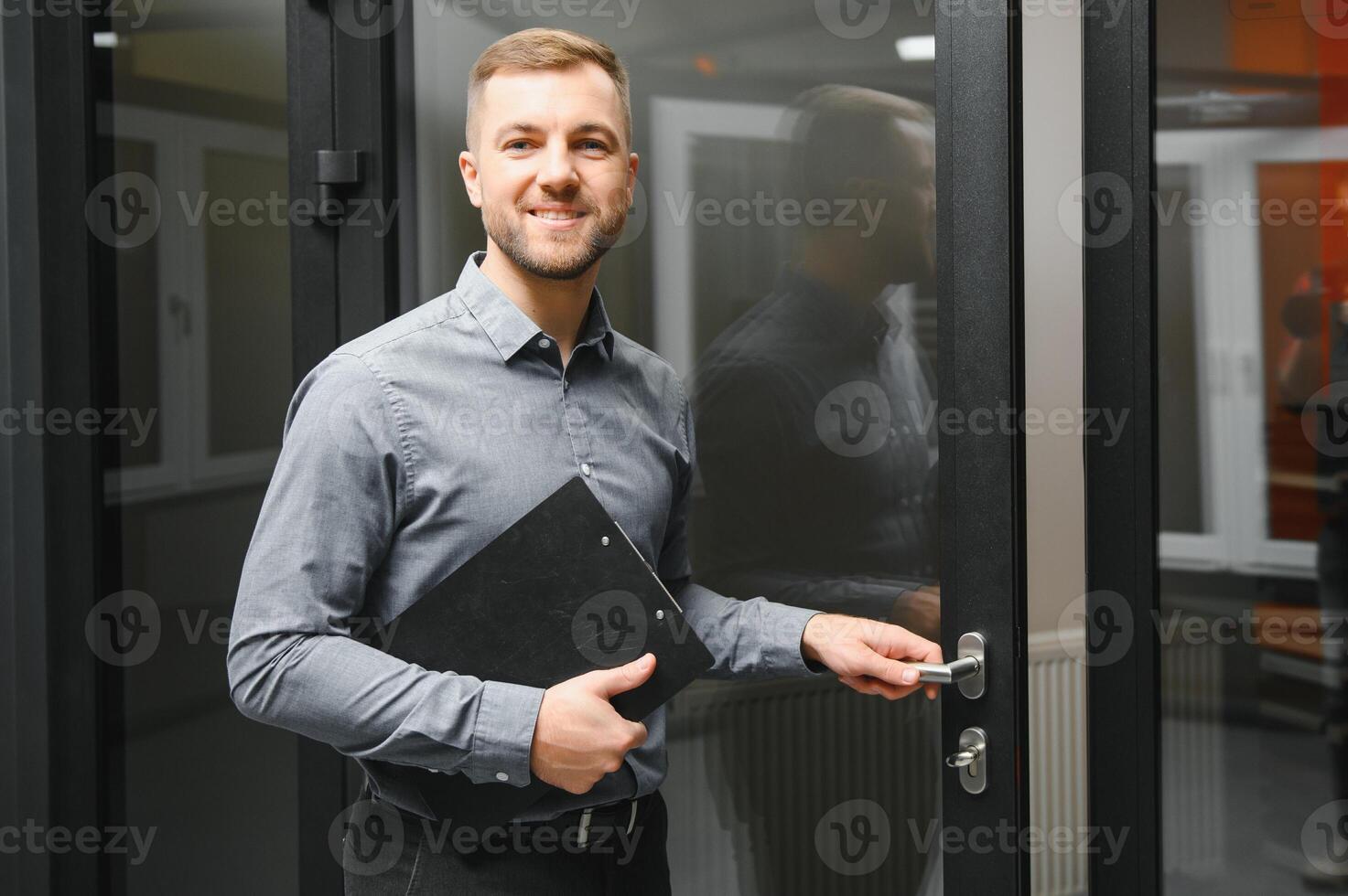 Friendly seller in window shop with keys. A large selection of windows and doors for the house. Home renovation concep photo