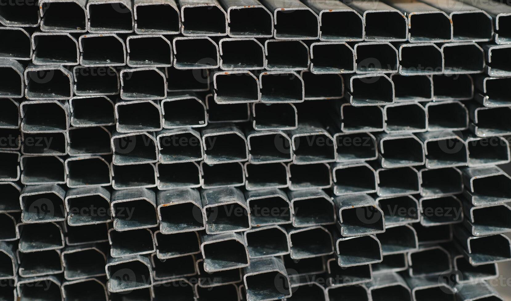 Stack of rolled metal products, perspective view of steel pipes of rectangular cross-section photo