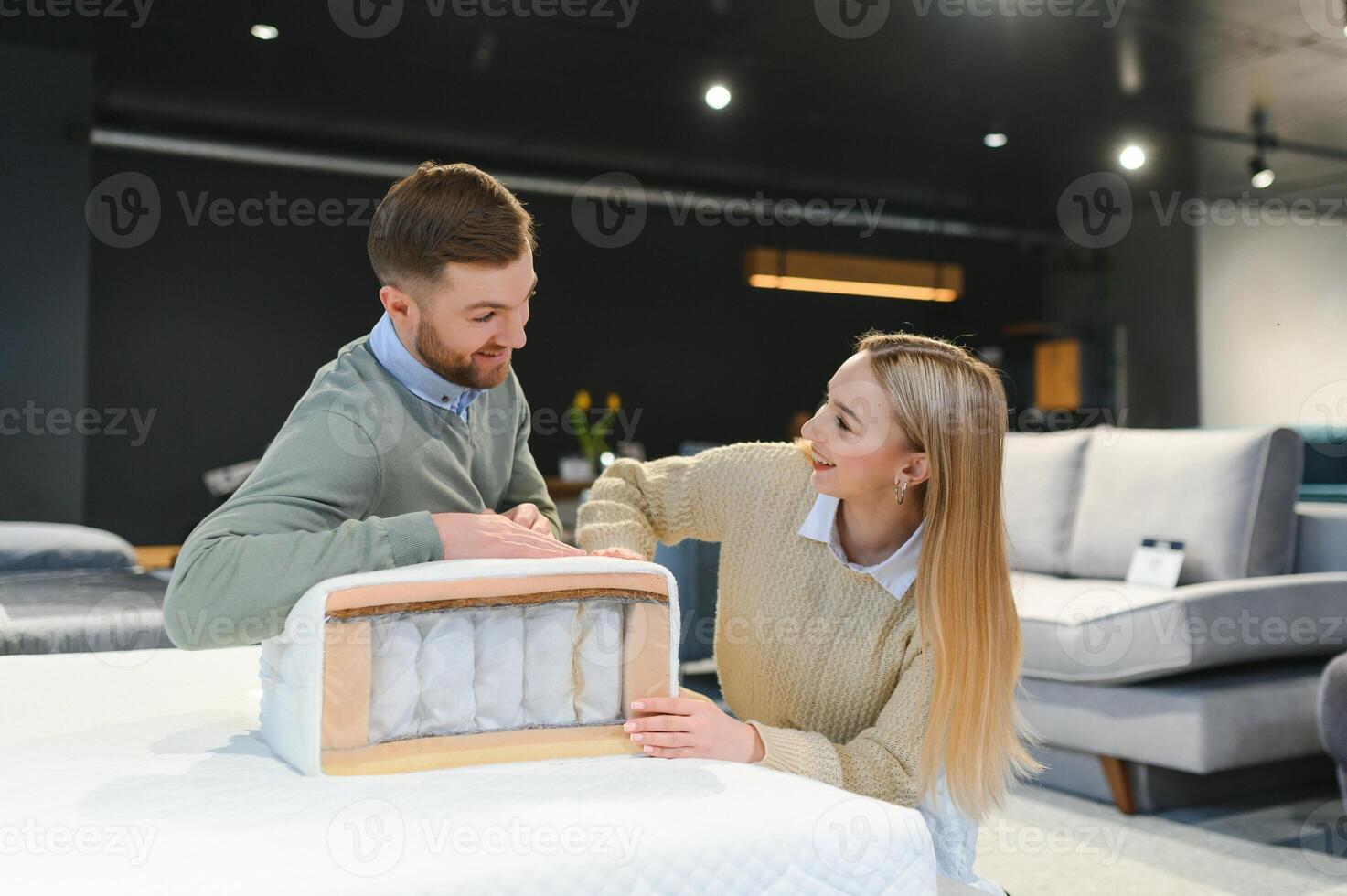 Happy couple choosing furniture in store photo
