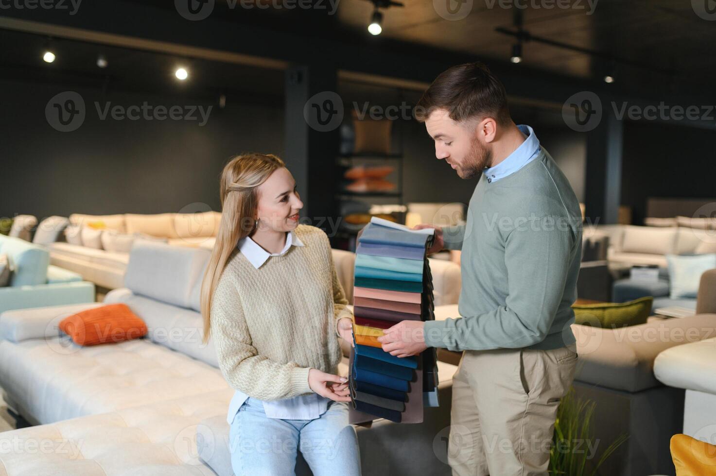 Couple choosing sofa in furniture store photo