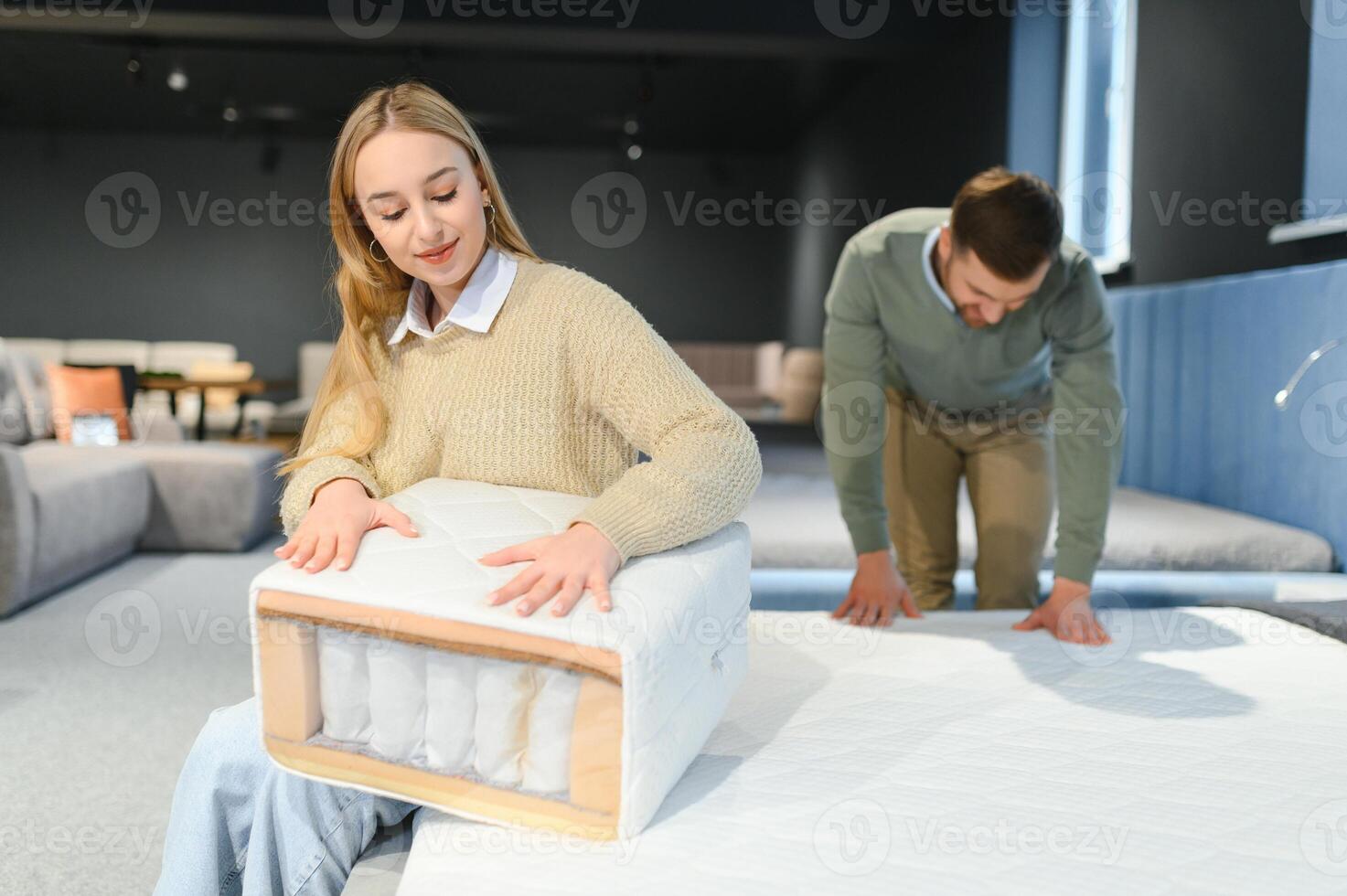 Couple choosing sofa in furniture store photo