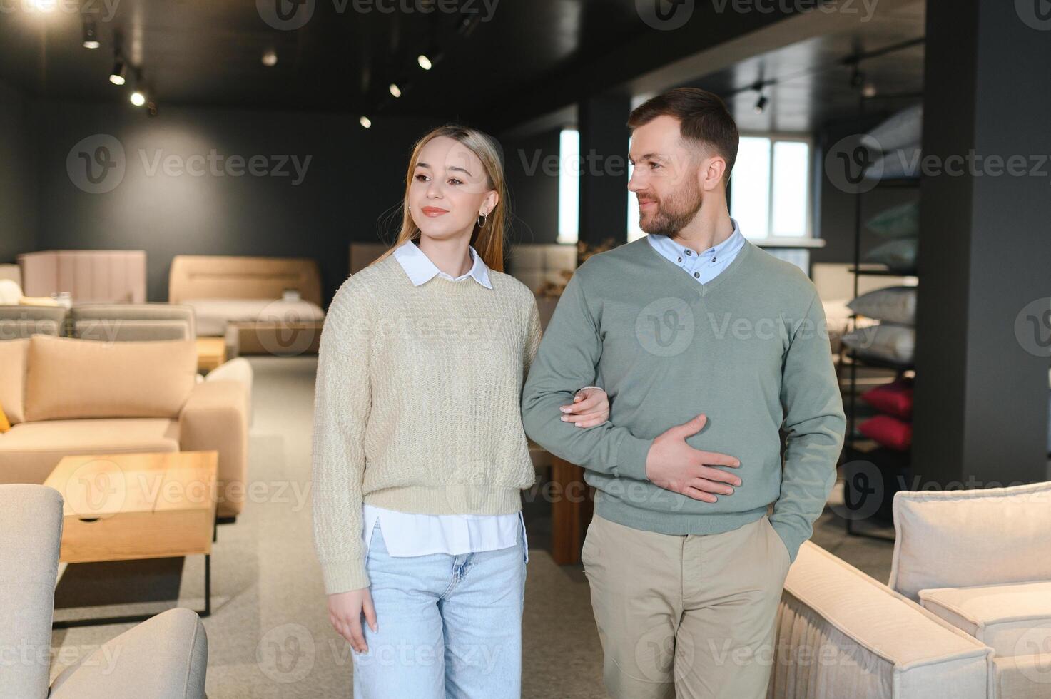 Married couple chooses the best new sofa in a furniture store photo