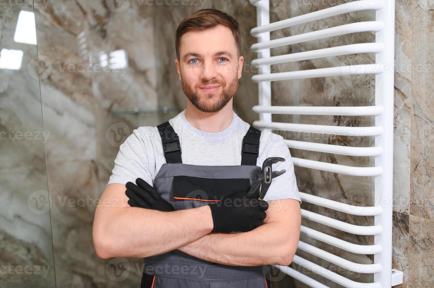 Plumber hanging towel rail. worker photo