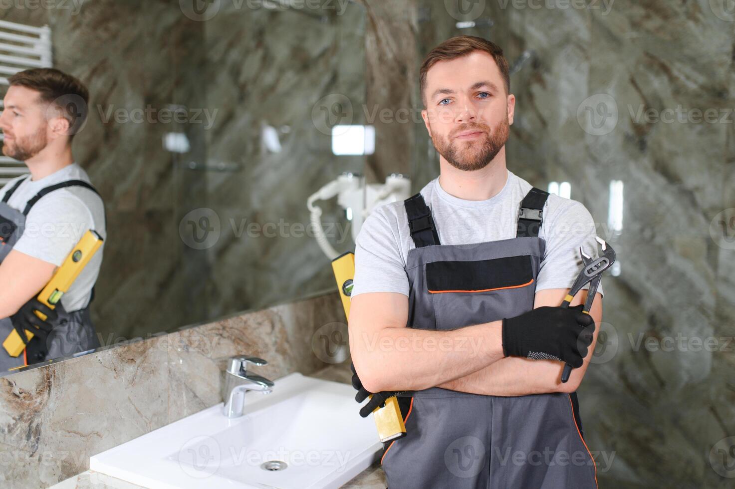 A man is setting the washbasin over the cabinet in the bathroom photo