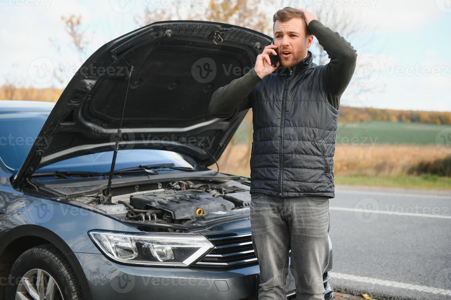 The car broke down, smokes from under the hood, the driver shocked photo