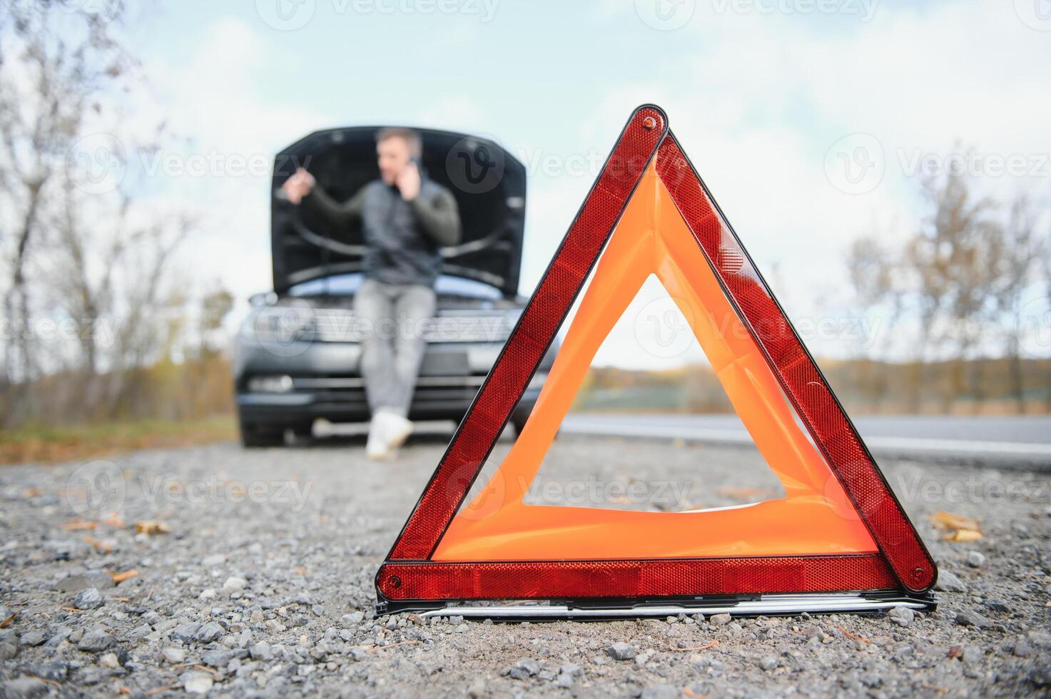 The car broke down, smokes from under the hood, the driver shocked photo