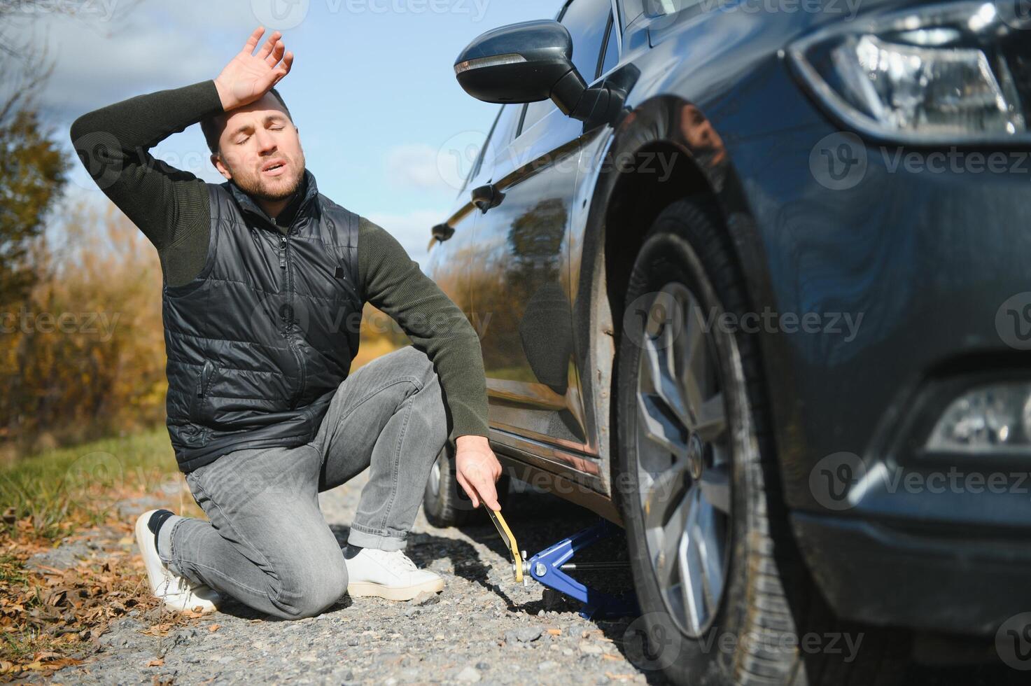 a man feel stress because his car is broken down photo