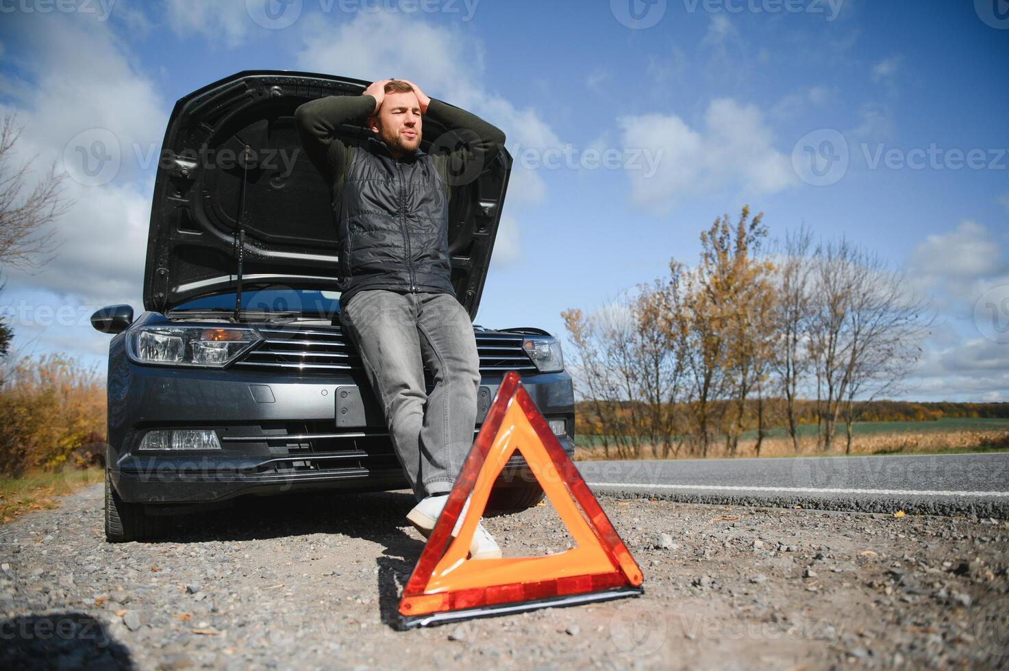 a man feel stress because his car is broken down photo