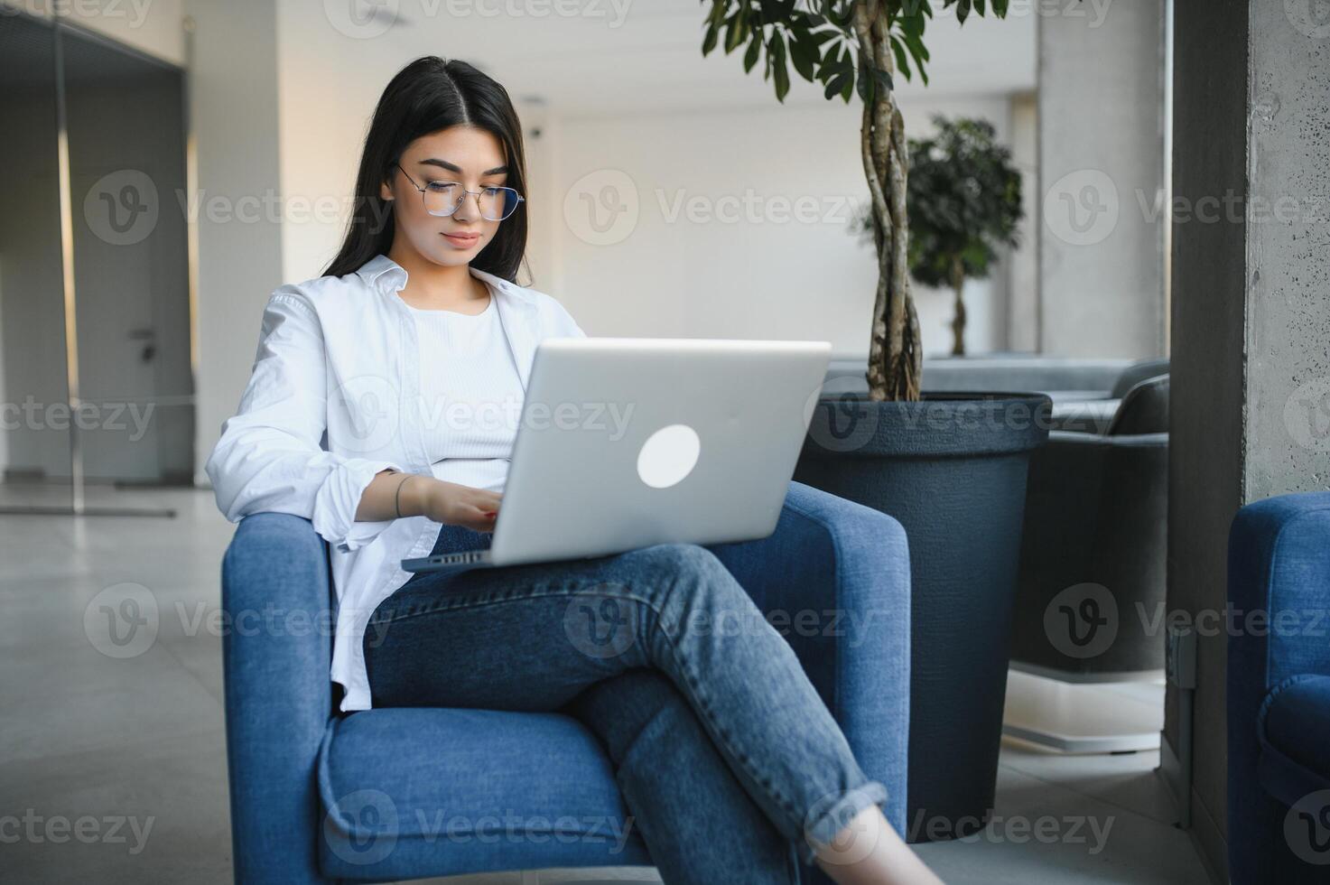 Beautiful Caucasian woman dreaming about something while sitting with portable net-book in modern cafe bar, young charming female freelancer thinking about new ideas during work on laptop computer photo