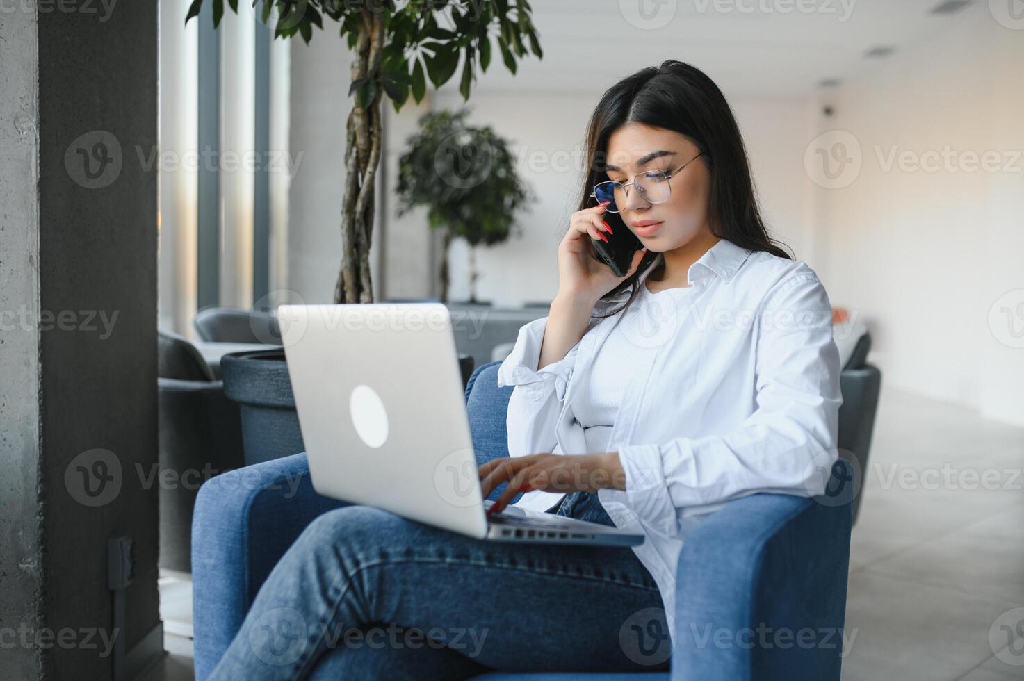 Beautiful Caucasian woman dreaming about something while sitting with portable net-book in modern cafe bar, young charming female freelancer thinking about new ideas during work on laptop computer photo