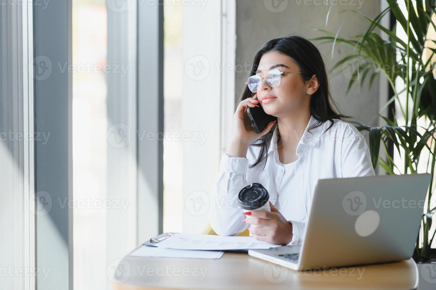 Beautiful Caucasian woman dreaming about something while sitting with portable net-book in modern cafe bar, young charming female freelancer thinking about new ideas during work on laptop computer photo