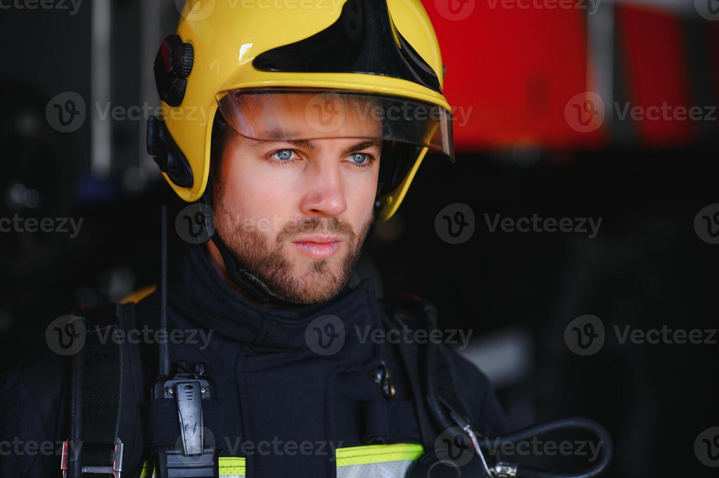 Photo of fireman with gas mask and helmet near fire engine
