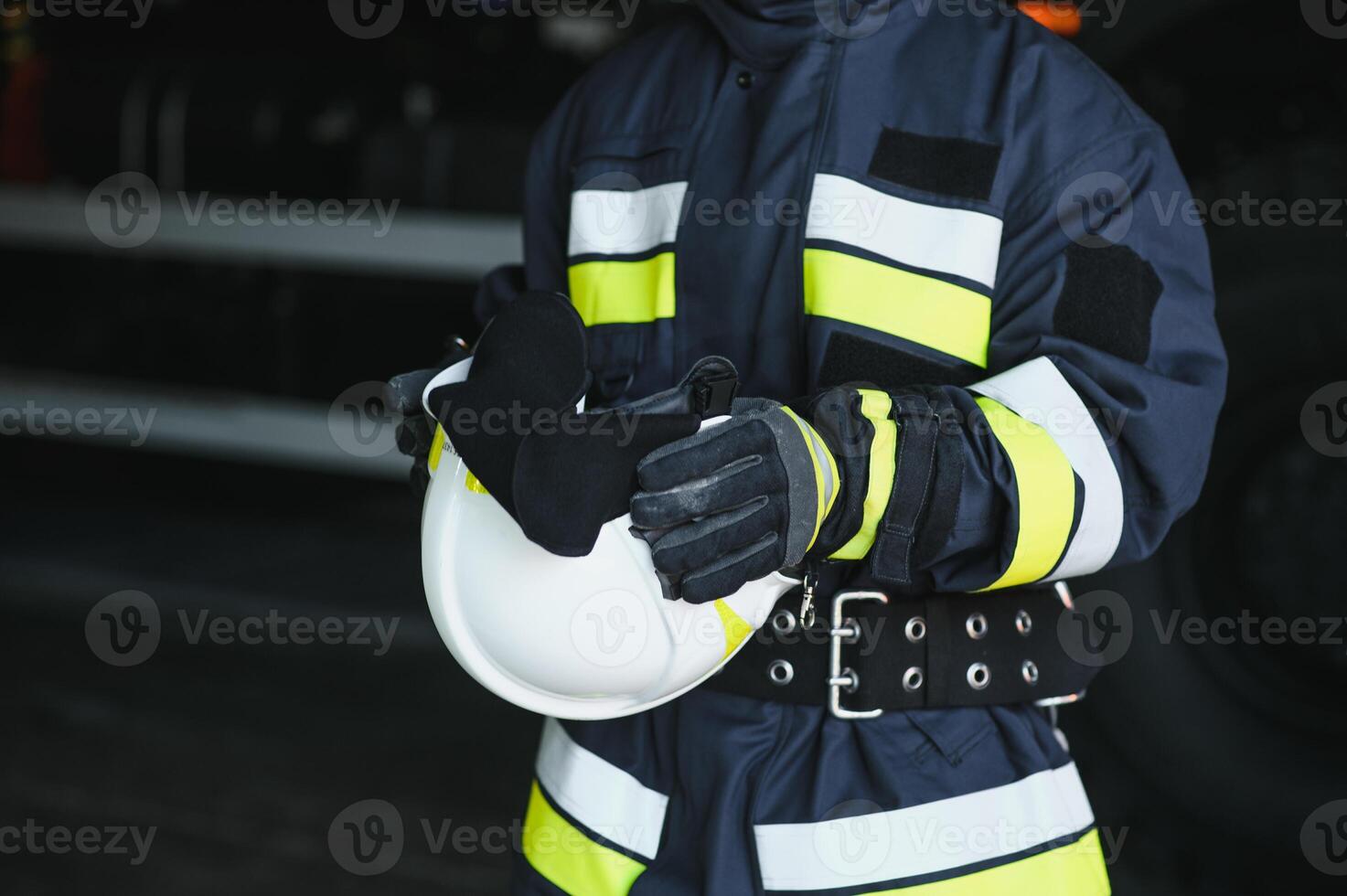 Portrait of a firefighter standing in front of a fire engine photo