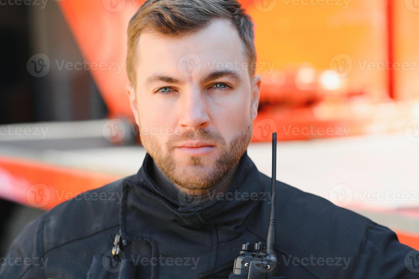 Firefighter portrait on duty. Photo fireman with gas mask and helmet near fire engine.