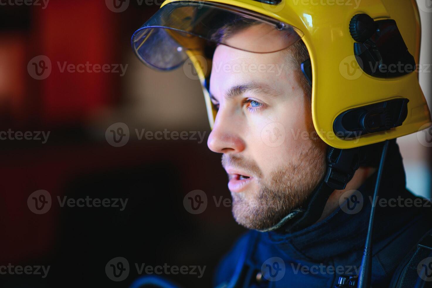 Fireman, firefighter in action standing near a firetruck. Emergency safety. Protection, rescue from danger. photo