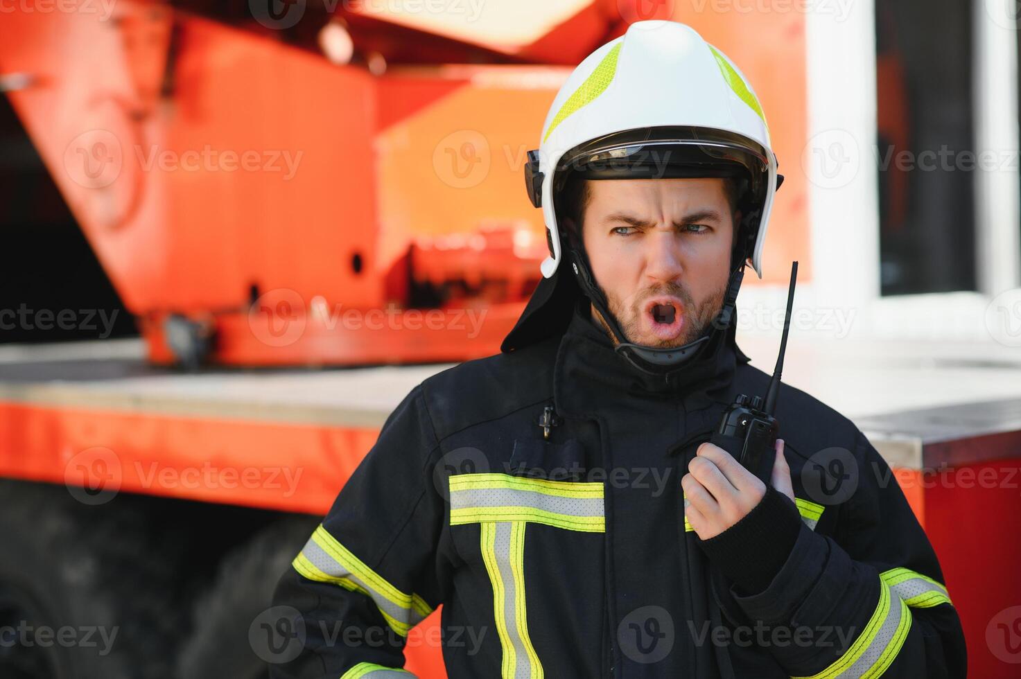 Photo of fireman with gas mask and helmet near fire engine