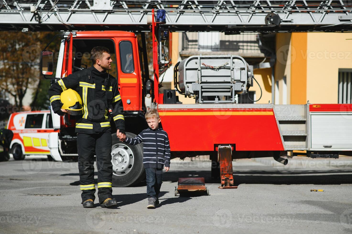 Firefighter holding child boy to save him in fire and smoke,Firemen rescue the boys from fire photo