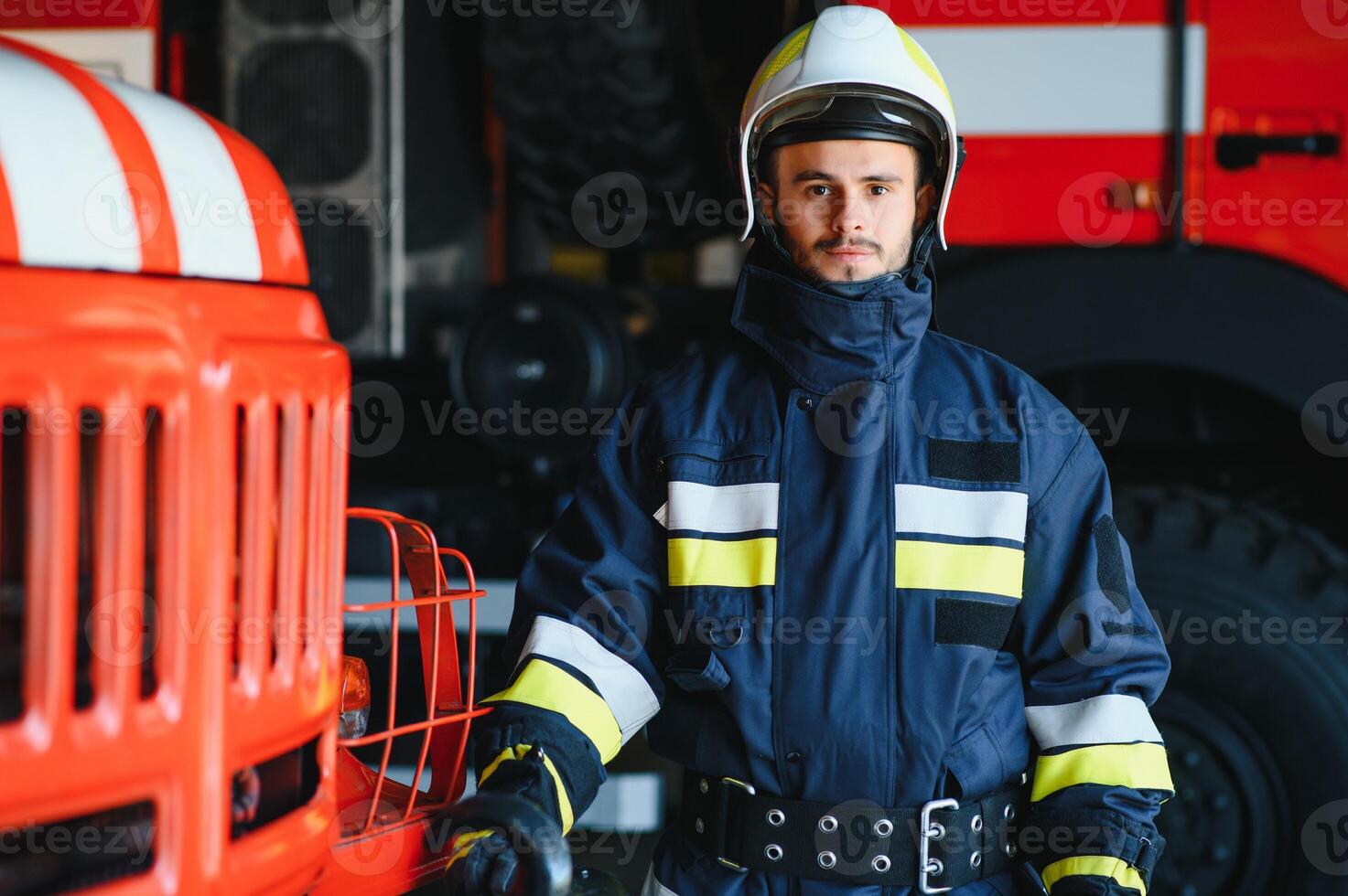 Photo of fireman with gas mask and helmet near fire engine