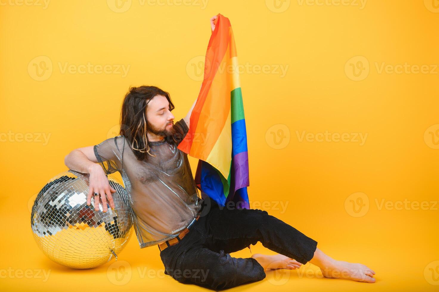Young, handsome gay man on a colored background in the studio. LGBT concept. photo