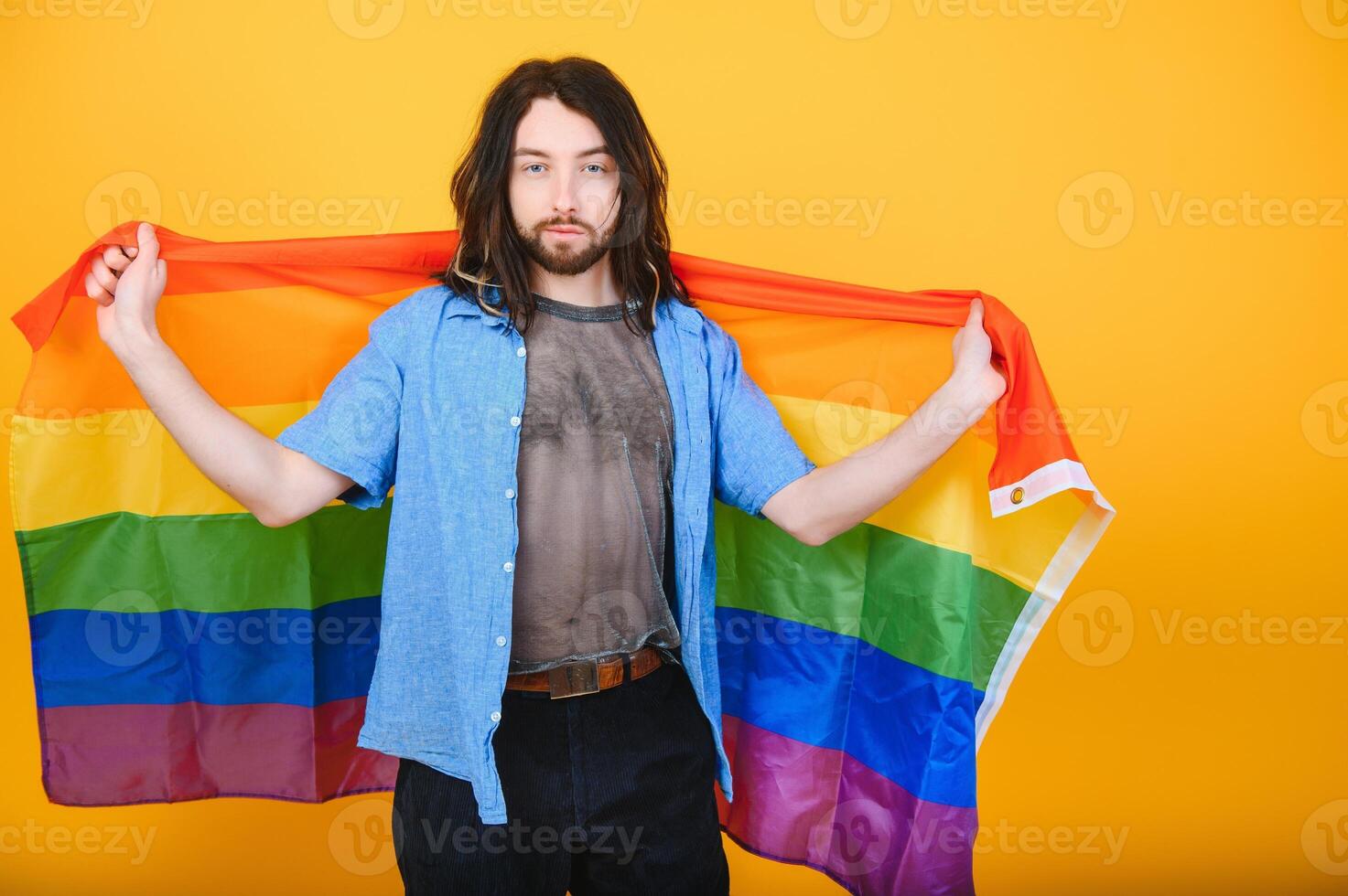Youth transgender LGBT with Rainbow flag on shoulder isolated color background. gender expression pride and equality concept. photo