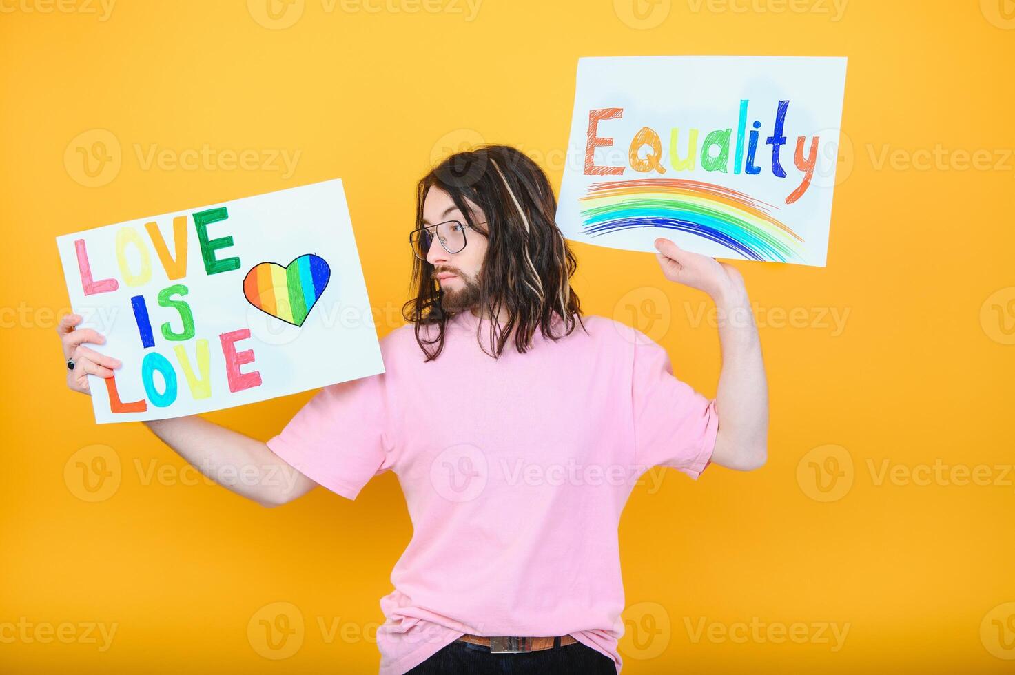 Hands of gay man holding lgbt banner on rainbow flag background lgbt symbol photo