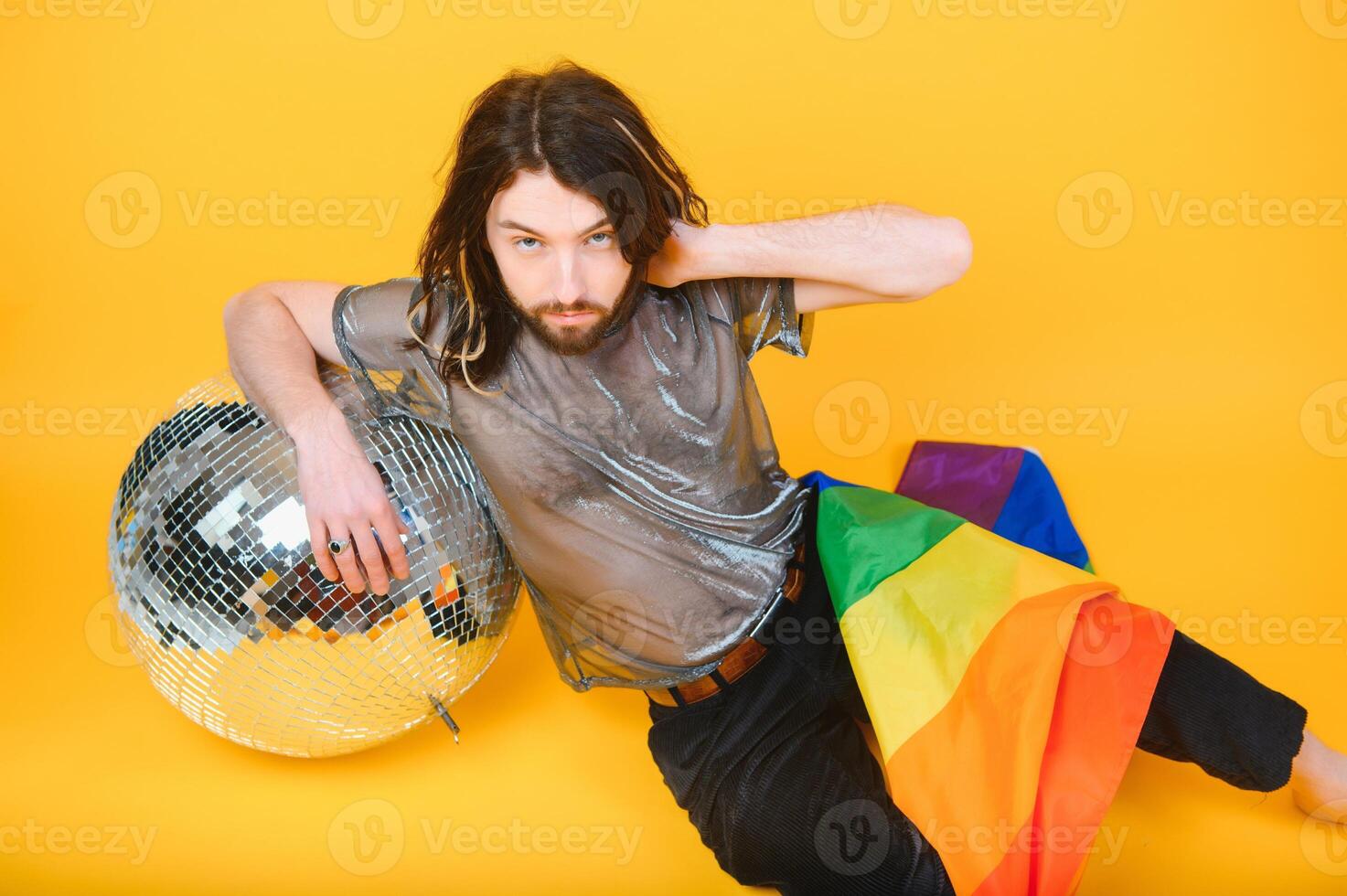 Youth transgender LGBT with Rainbow flag on shoulder isolated color background. gender expression pride and equality concept. photo