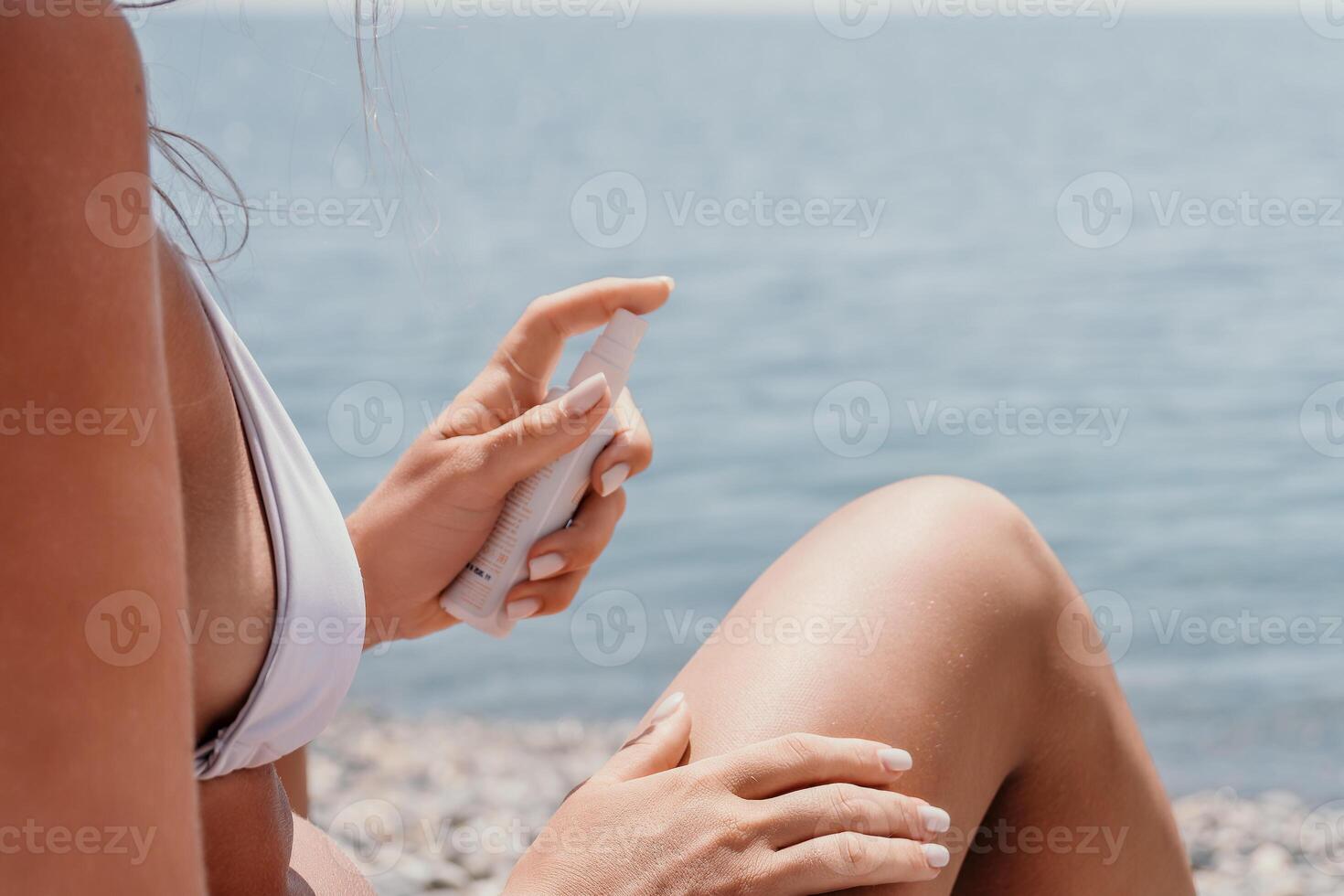 Woman sunscreen sea. Happy lady applies sunblock cream on tanned skin before sunbathing. Female On Sea Vacation Holiday Resort. Woman Use Suncare Lotion On Beach, Applying Sunscreen Lotion On Body photo