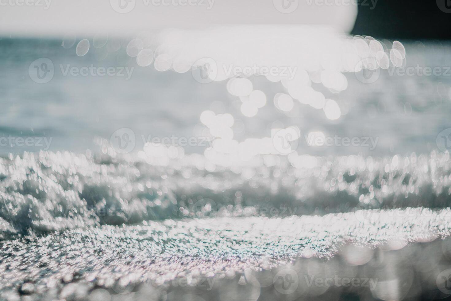 Abstract nature summer ocean sunset sea background. Small waves on water surface in motion blur with bokeh lights from sunrise. Holiday, vacation and recreational background concept. photo