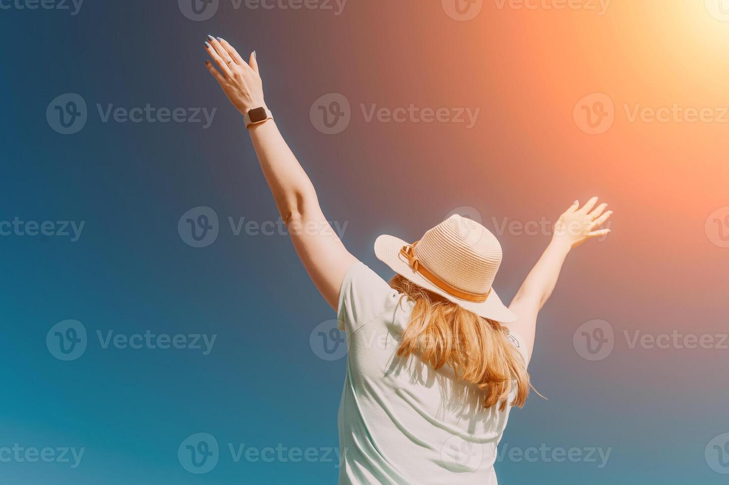 Woman travel sea. Happy tourist in hat enjoy taking picture outdoors for memories. Woman traveler posing on the beach at sea surrounded by volcanic mountains, sharing travel adventure journey photo