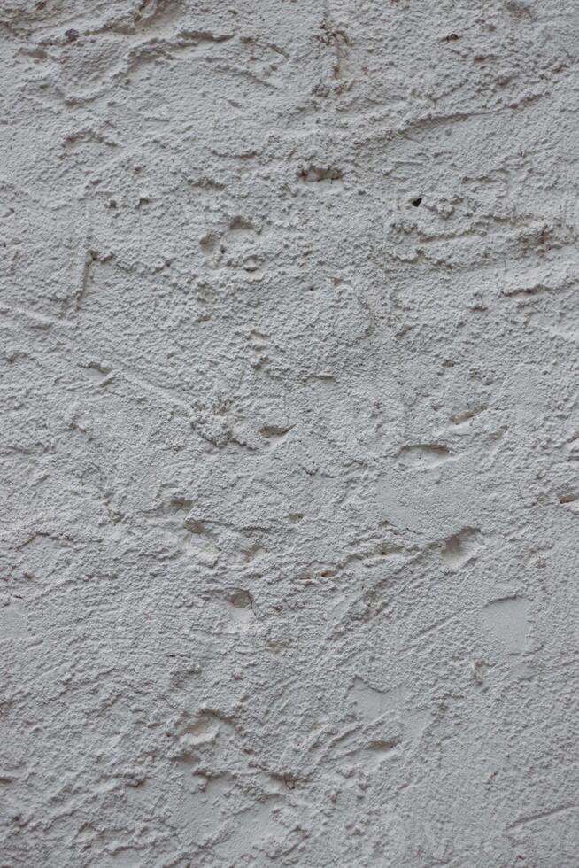 Wall fragment with scratches and cracks. Concrete cement wall texture with three dimensional elements. Modern design. Retro grunge style. Copy space. Wallpaper, banner, textures, background photo