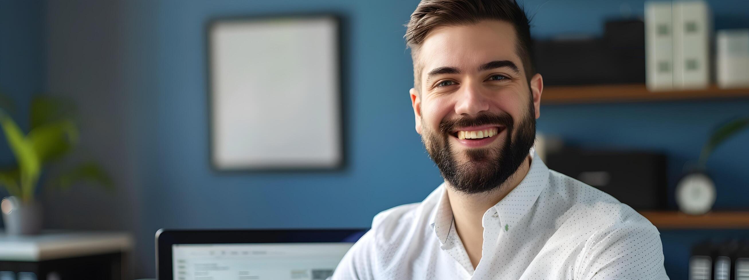 Smiling Young Professional Working at Desk in Modern Office Setting photo
