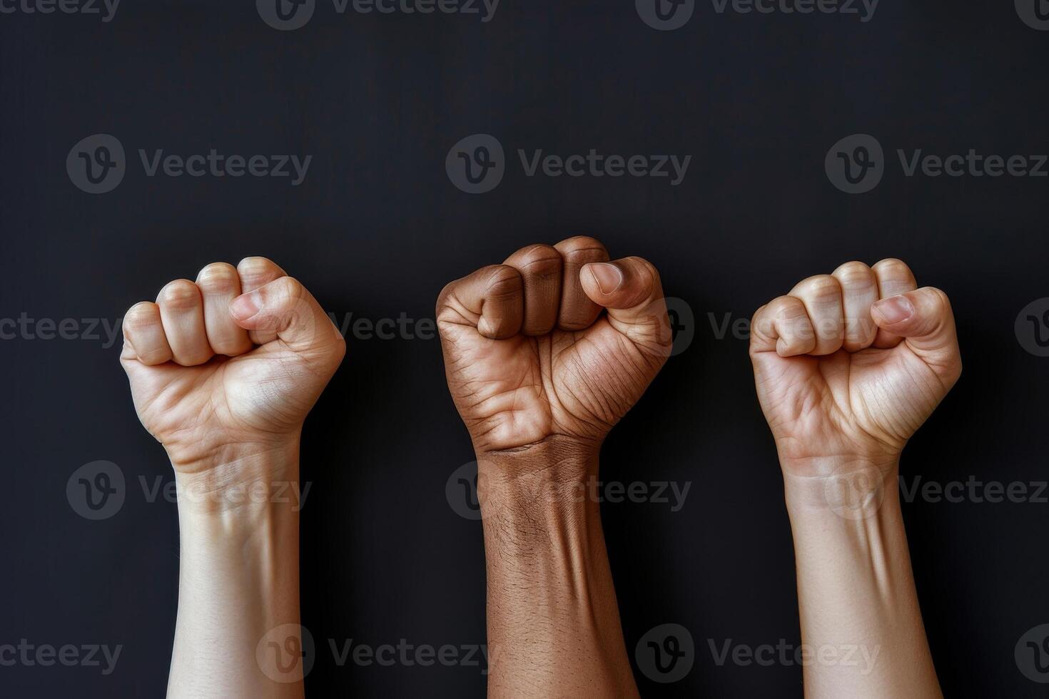 Fists Raised In Unity Against Black Background photo